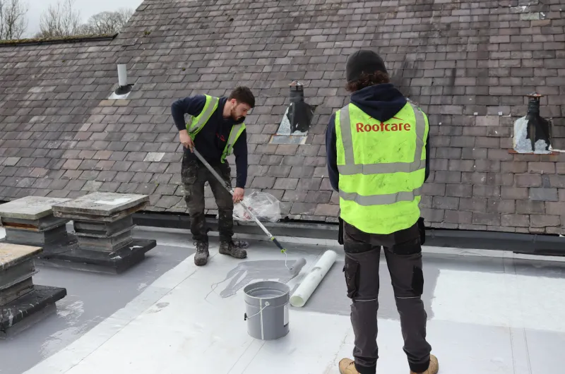 Roofcare team laying flat roof at The Malthouse Farm, Chorley